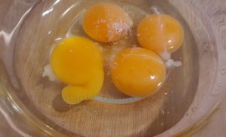 Разбиваем четыре яйца и щепотку соли